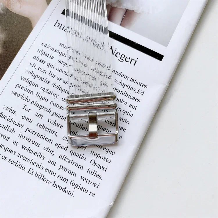 Candy color transparent TPU watchband for Apple Watch with silver buckle on magazine background.