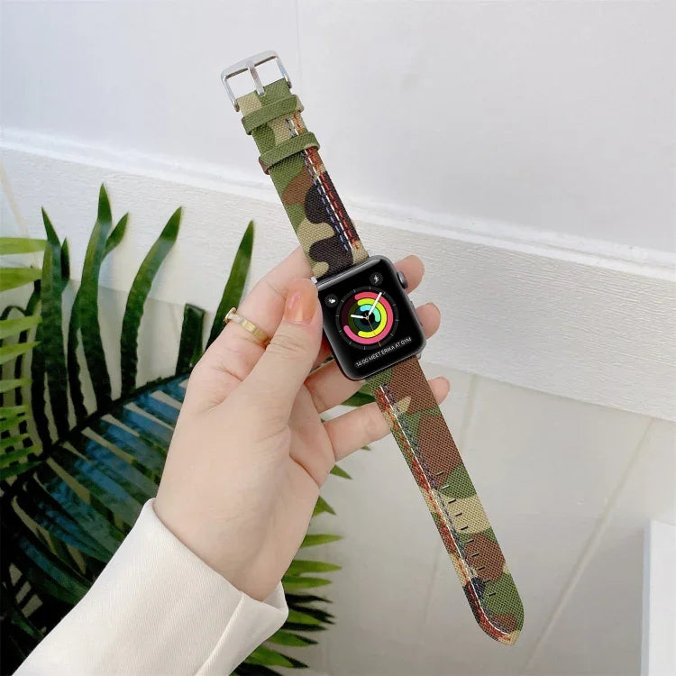 Canvas replacement strap for Apple Watch in camouflage pattern, comfortable and adjustable, shown on a wrist.