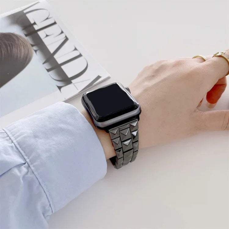 Ceramics replacement strap for Apple Watch seen on wrist with a stylish rhombic grid design.